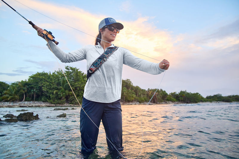 An angler casting in the Honduras waters during sunrise.