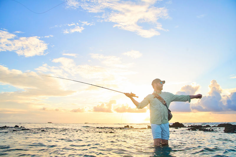 Man fly fishes on the beach in Honduras