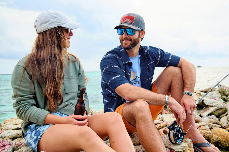 Anglers sit and enjoyr a drink.