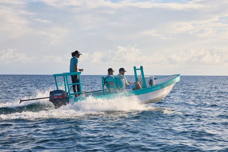 Two anglers and their guide travel across open ocean .