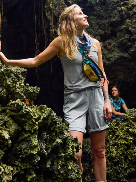 Woman hiking in caves of Honduras in grey tank top
