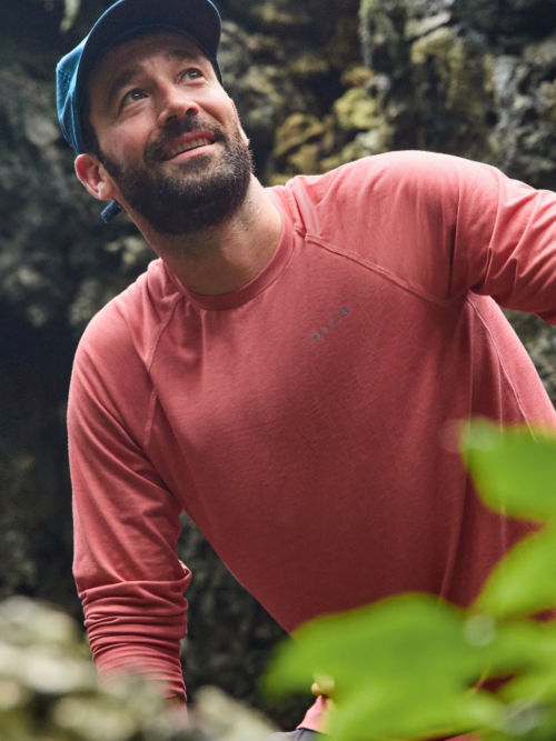 Man in DriCast™ shirt walking through a Honduran forest.