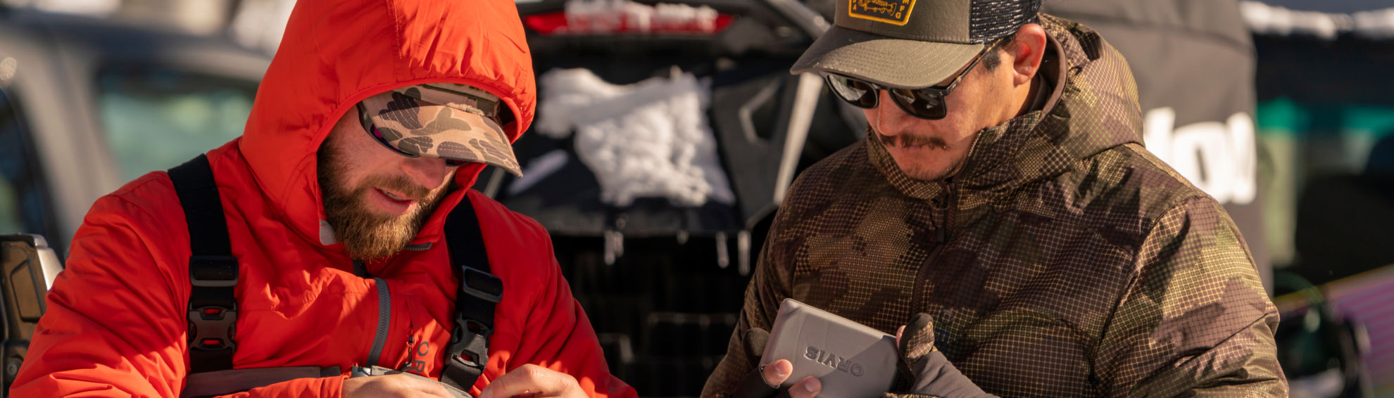 Two anglers gear up before a trip