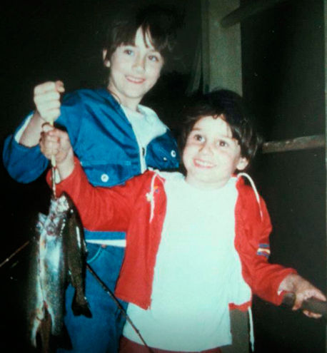 Young Jeff and his older sister hold up several fish they caught.