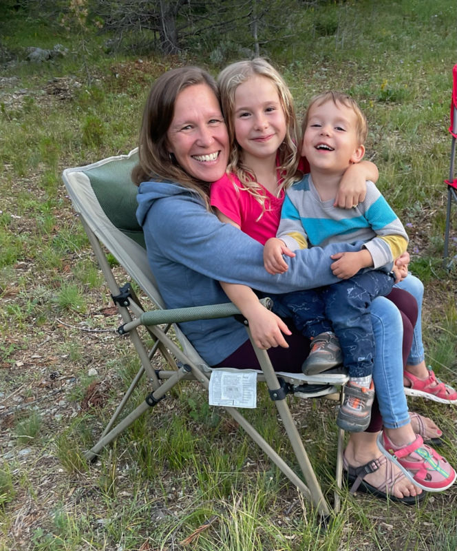 Laura Schaffer and her two children in a smiling embrace.