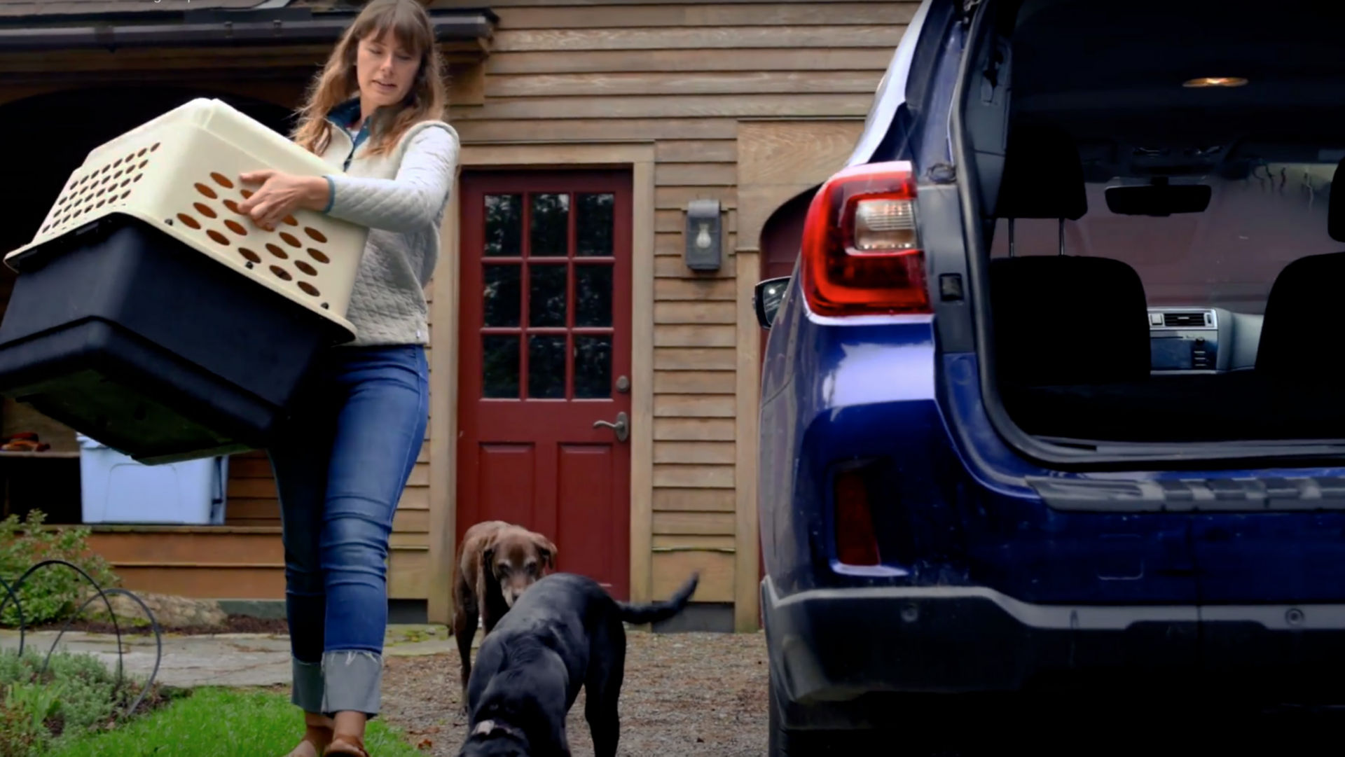 Hannah packing up the car with her two dogs
