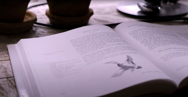 A close-up of a duck soup recipe in an open book.