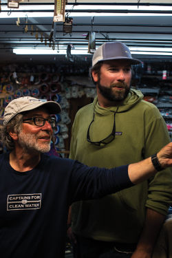 Tom shows something to Orvis instructor Pete Kutzer.