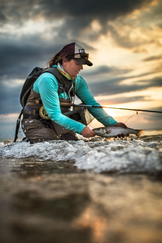 Abbie Mahurin tying a boat down to a trailer
