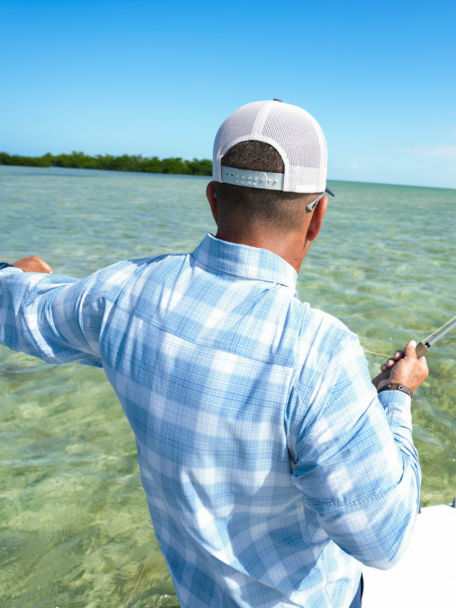 Man fly fishes from a boat off the coast of Florida