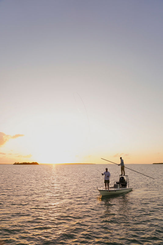 A sunrise over the ocean with a boatload of anglers aboard.
