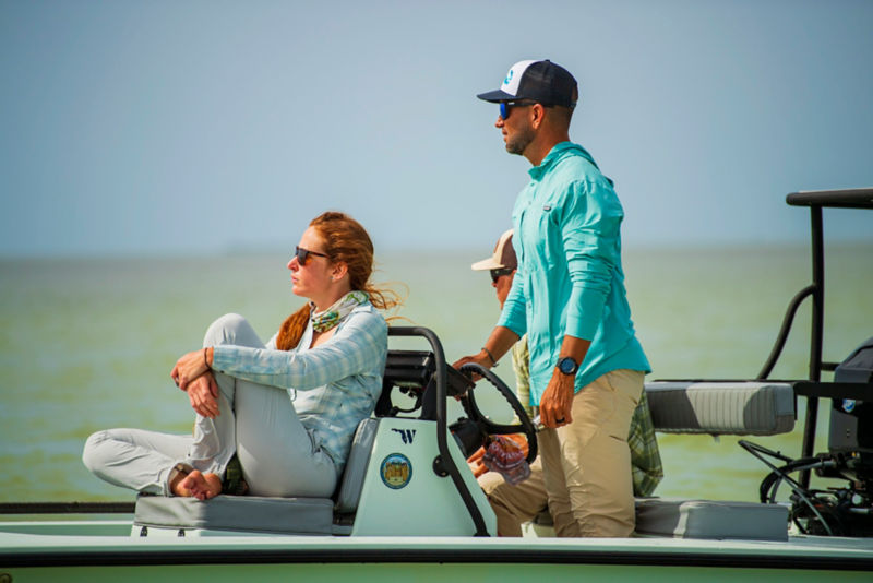 Anglers drive out to fishing waters on their pontoon boat.
