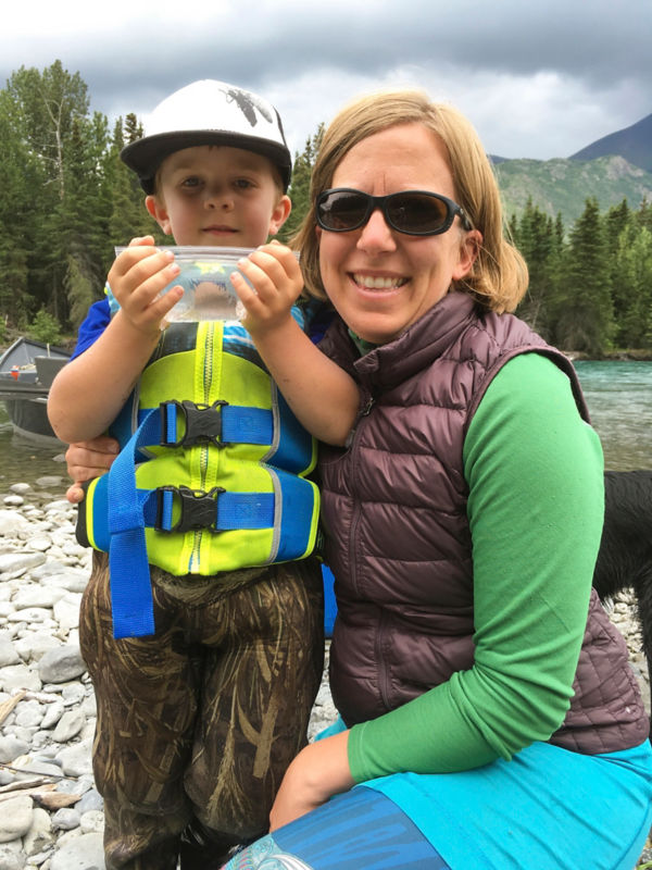 Nelli Williams poses with her son showing off a cool nature find.