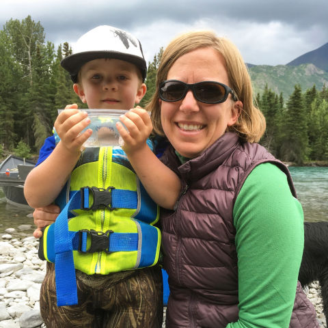 Nelli Williams poses with her son showing off a cool nature find.