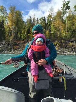 Nelli Williams and her baby daughter fishing in a canoe.