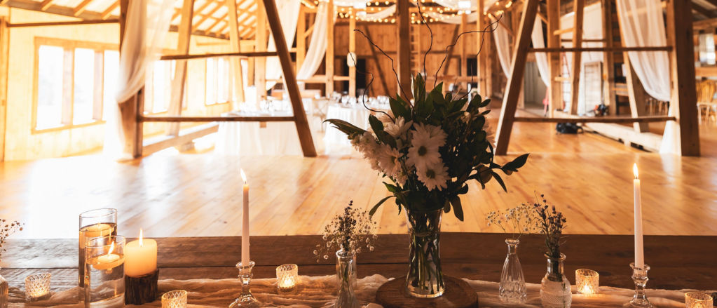 Inside the rustic wedding barn showing the lighting and table setting.