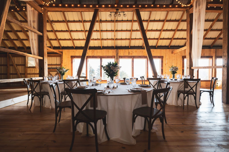 A table set for a wedding with flowers and place settings.