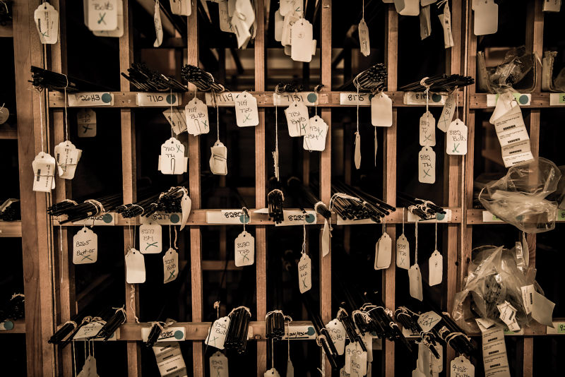 Fly rod pieces stacked in multiple shelves.