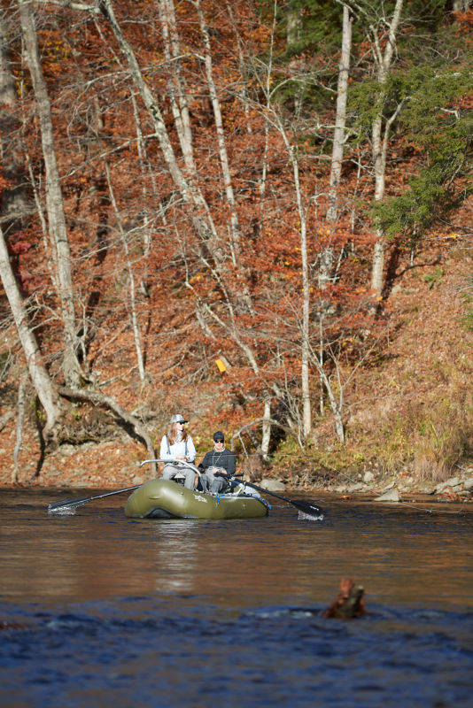 Two people fishing from a raft.