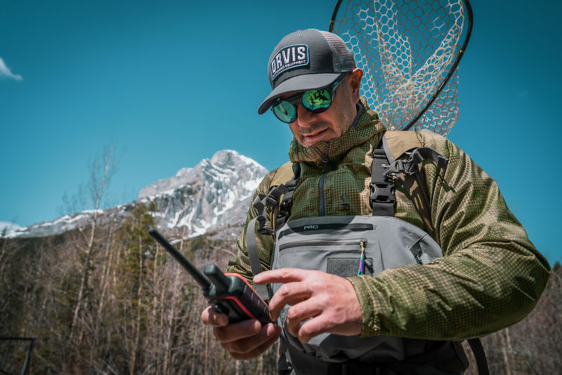 An angler using a walkie talkie to communicate.