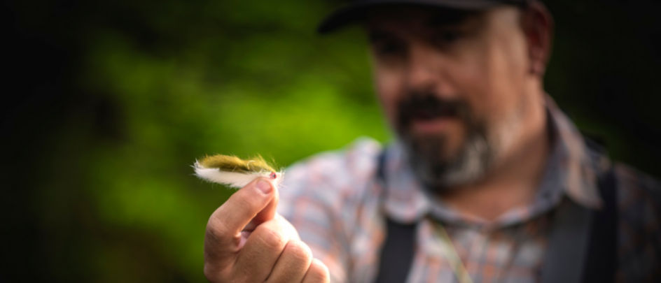 Man holding a fuzzy fly fishing streamer