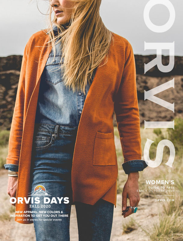 A close-up of a woman wearing a denim shirt and sunflower yellow cardigan.