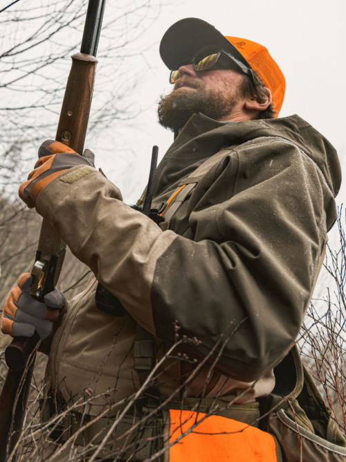 A hunter in a PRO Jacket makes his wall through tall briars.