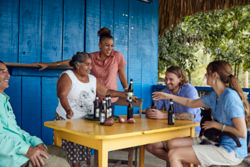Five people drinking at an outdoor table