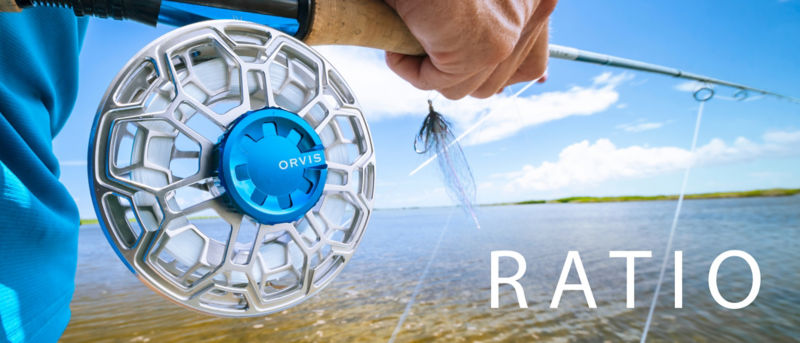 A close up image of the silver and blue Orvis Ration Reel on an angler's rod.