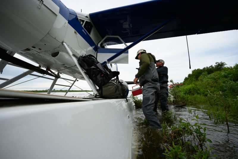 Two men in fishing gear by a float plane