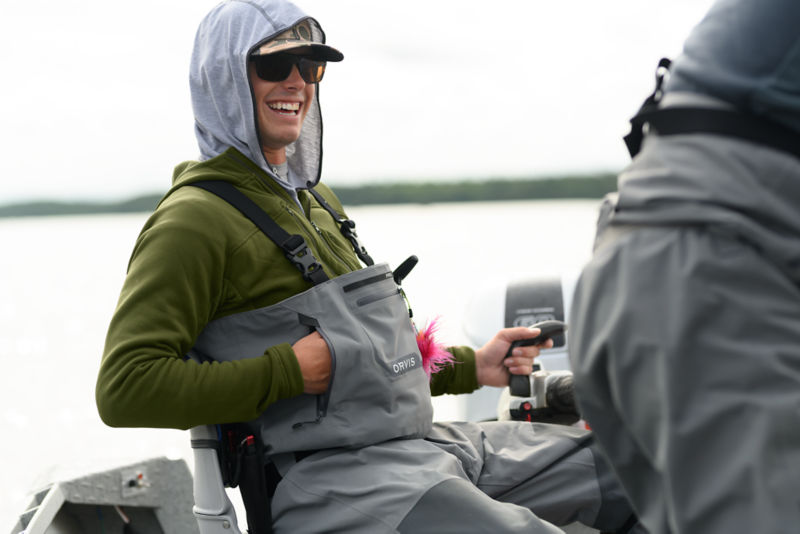 A smiling man wearing waders.