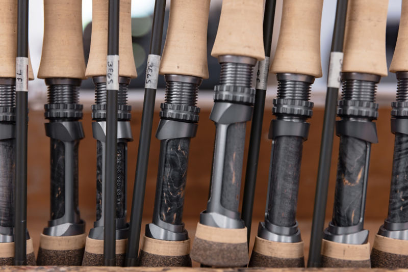 The butts of a group of fly rods in a rack.