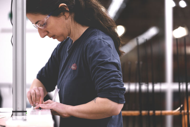 A rod shop builder works on a new fly rod.