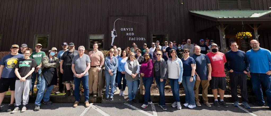 The employees of the Orvis Rod Shop stand outside the factory in the sunshine