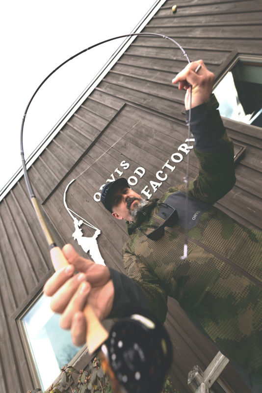 A rod shop builder tests the flexibility of a rod.