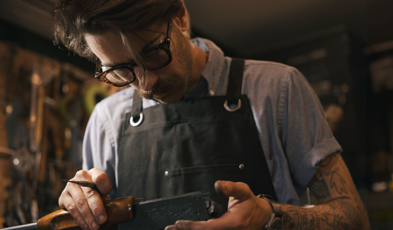 Orvis Gunsmith Jordan Smith at his workbench.