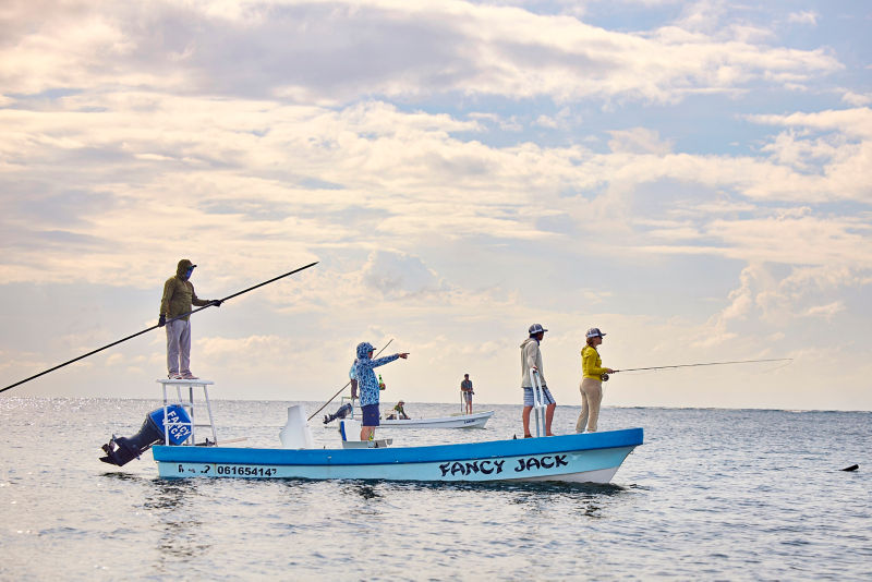 A group of anglers fish from their skiff of the coast of Mexico.