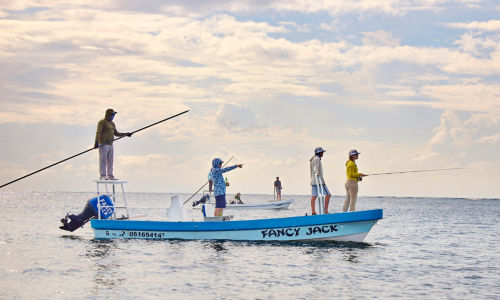 A group of anglers fish from their skiff of the coast of Mexico.