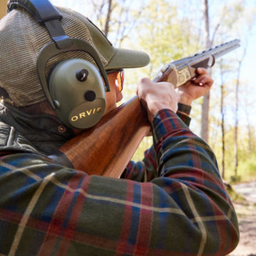 A hunting student shoots clays at the range.