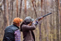 An instructor giving a hunter shooting instruction.