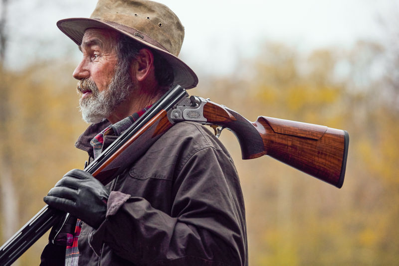 Trapper John Knuffke, with his shotgun hung over his shoulder, at Orvis's Sandanona Shooting Grounds.