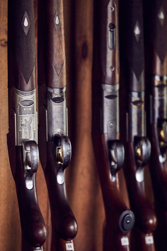 A close-up of guns stacked upright on a display.