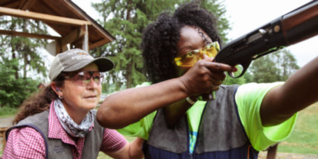 An instructor and student at a shooting range.