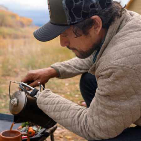 Chef Eduardo Garcia pours a cup of coffee at his campsite.