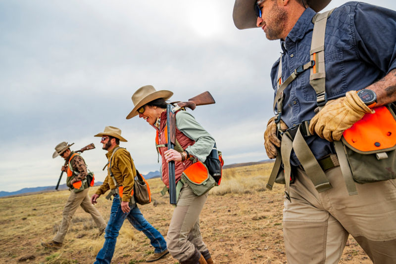 Hunter in Midweight shooting shirt walks with her fellows to the next field.