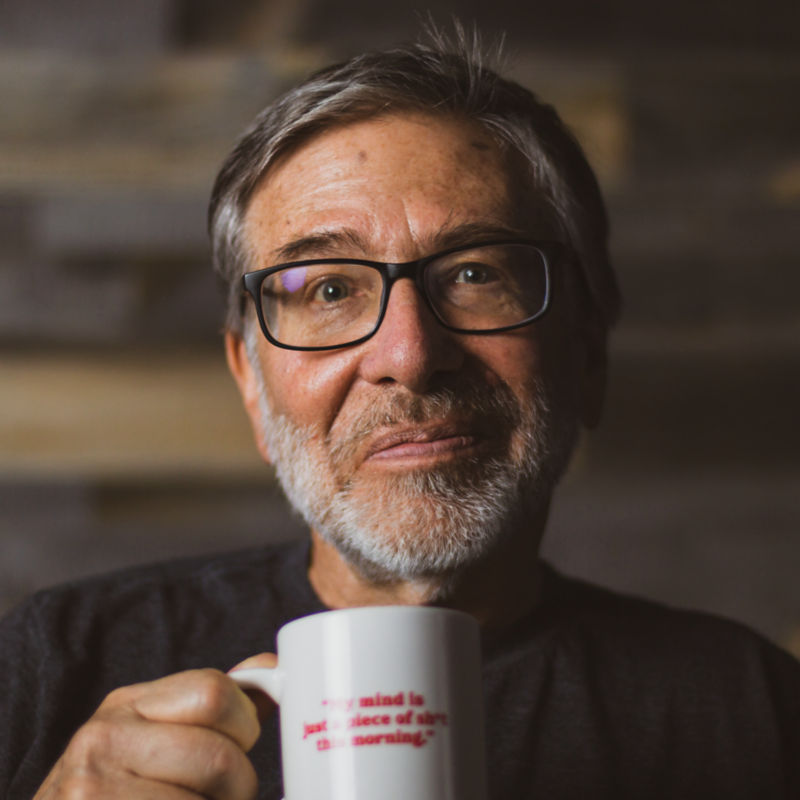A portrait of Tom Rosenbauer with a mug.