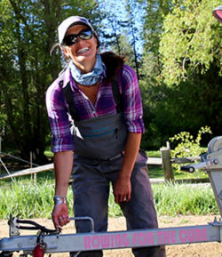 Whitney Milhoan standing in front of a boat trailer