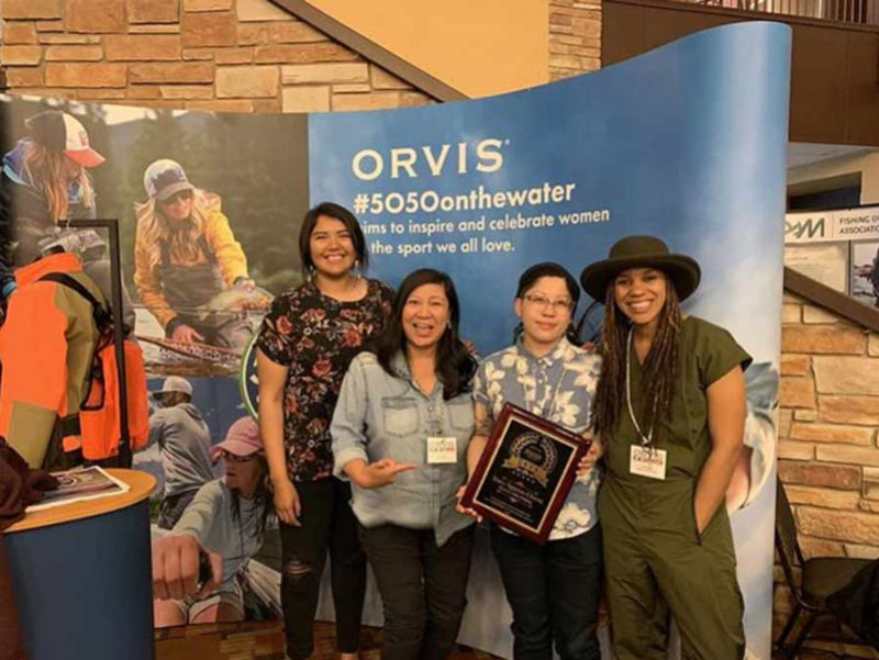 A group of women celebrating 5050 on the water.