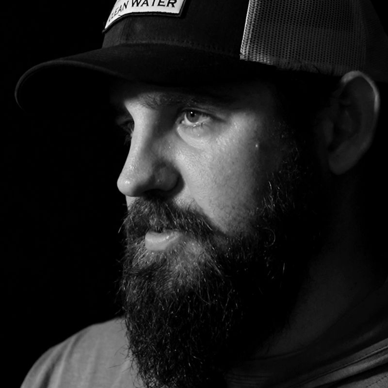 A headshot of Capt. Daniel Andrews in black-and-white
