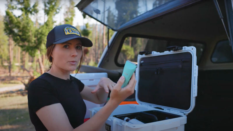 A green shaver being pulled from a white first aid kit
